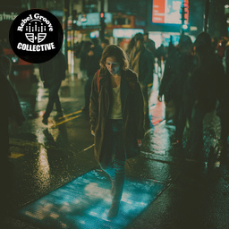 A person walking through a night-time city street